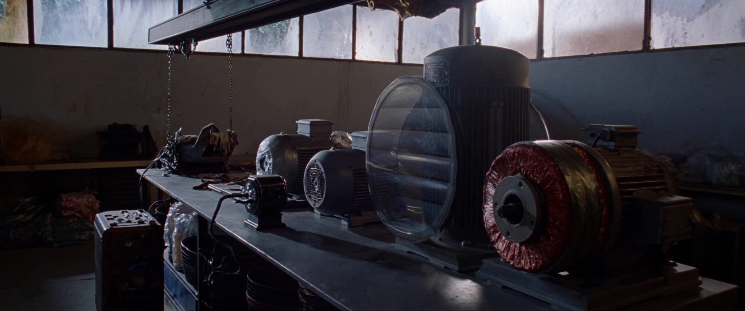 Industrial electric motors and a rewound stator on the bench at a motor repair shop